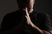 man with praying hands 