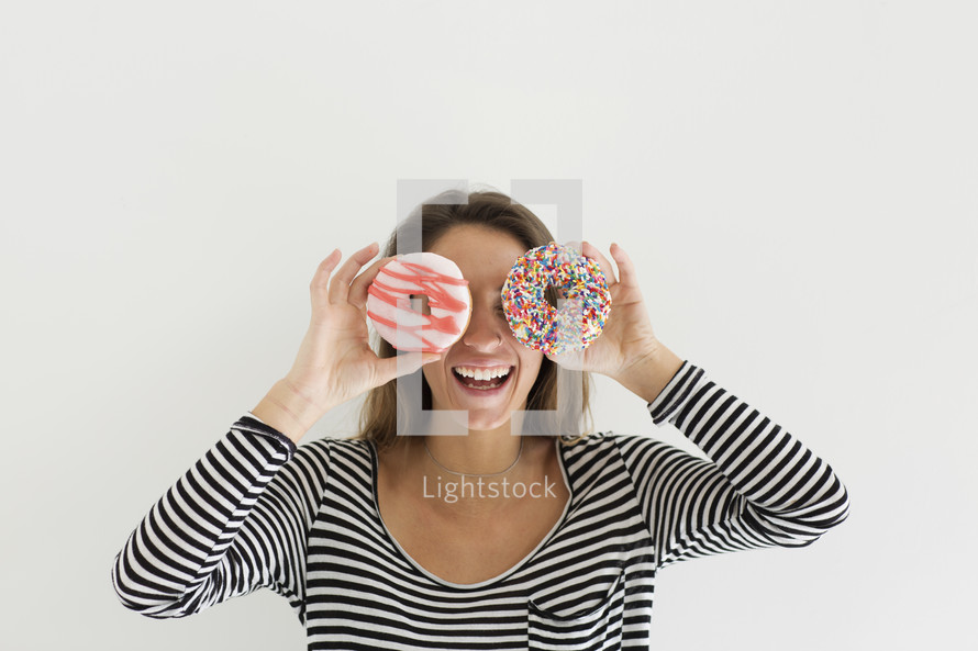a woman holding donuts