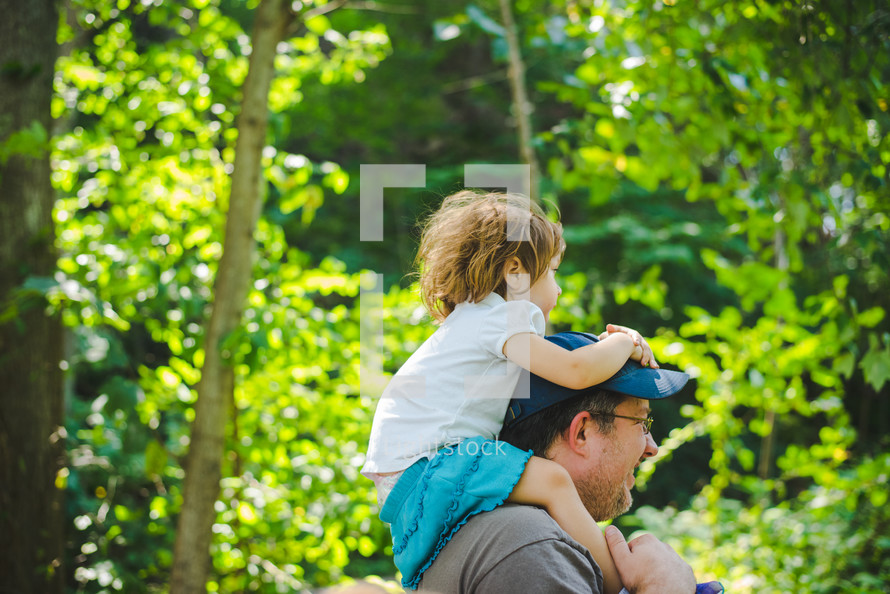 girl on father's shoulders 