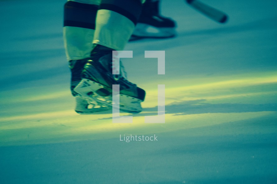 a hockey player standing in the spotlight on the ice 