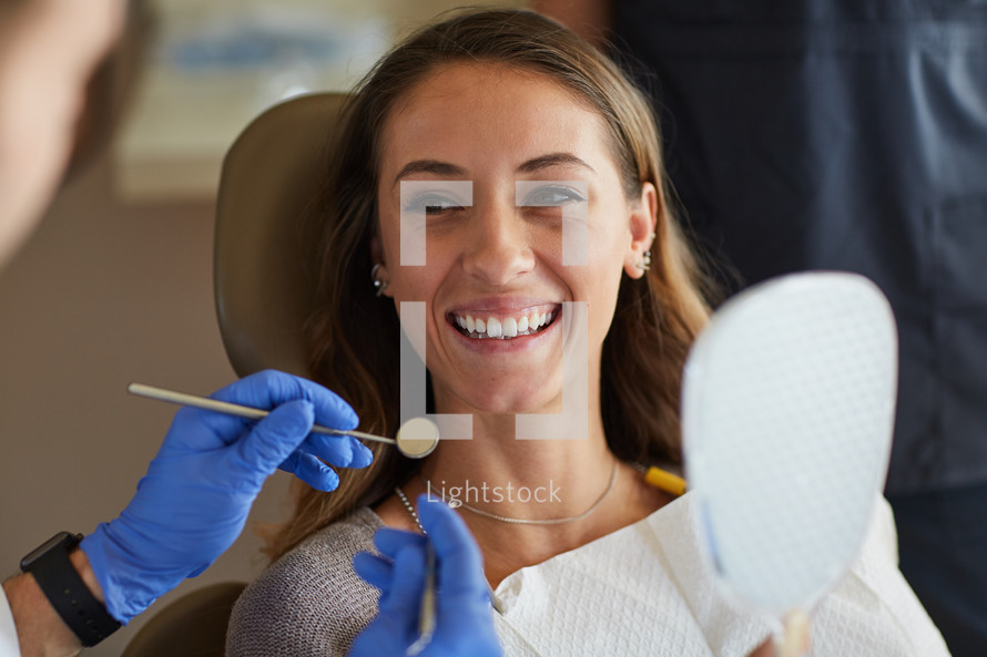 A smiling woman in a Dentist chair 