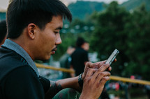 a man texting on a cellphone 