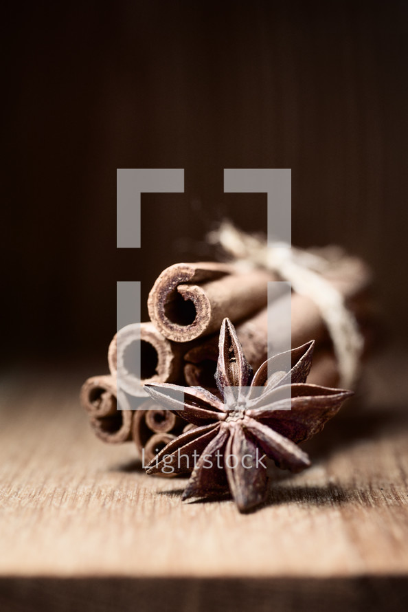 cinnamon and anise on wooden table with blurred background