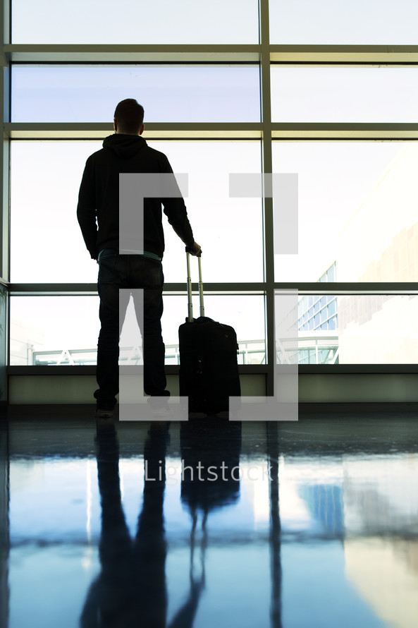 a man with luggage in an airport 
