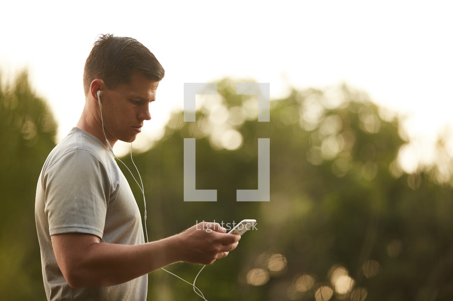 a man walking outdoors listening to his iPod 