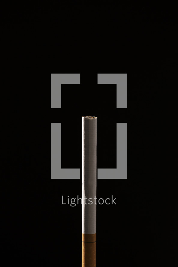 cigarette against a black background 
