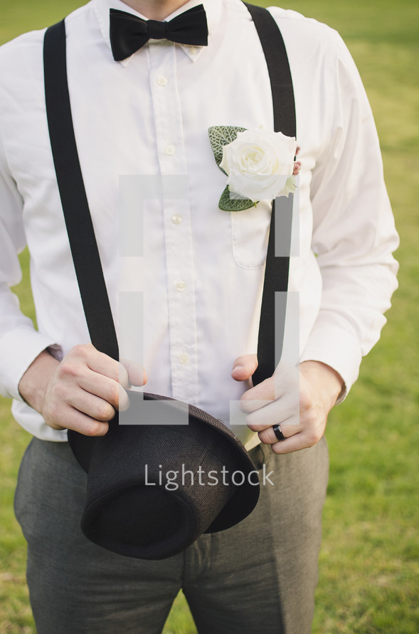 a groom in suspenders 