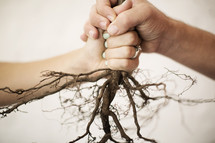 man and woman holding onto roots 