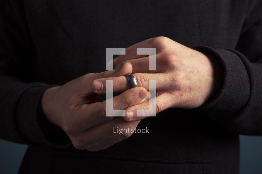 a man taking off his wedding ring 