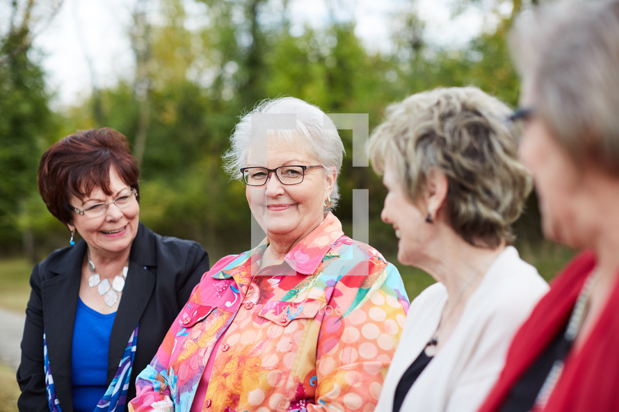 elderly women friends talking outdoors 