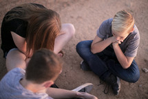 teens praying in a desert 