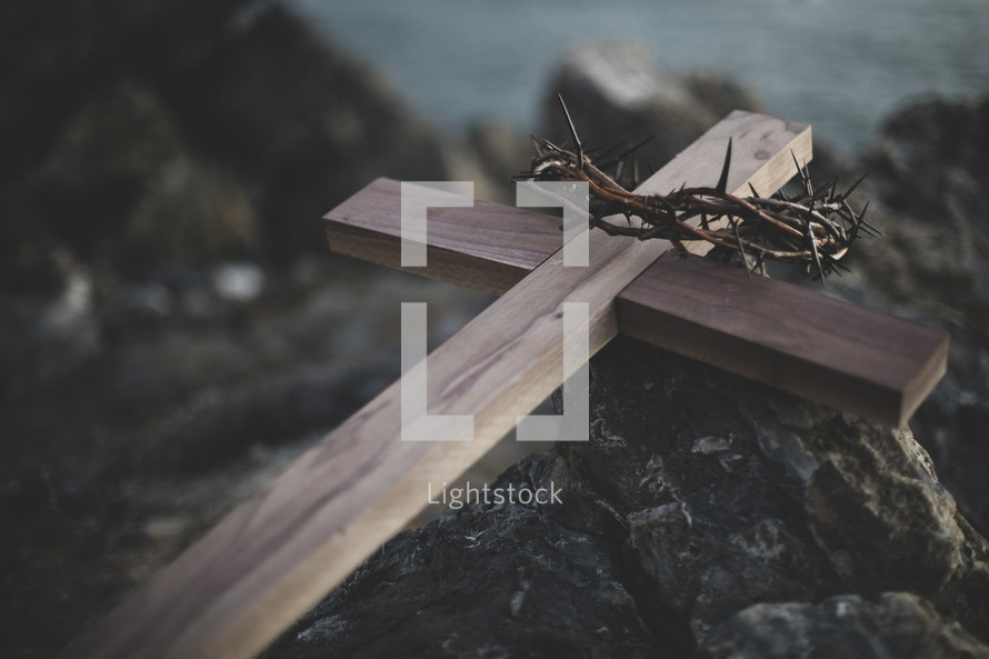 cross and crown of thorns on a rock 