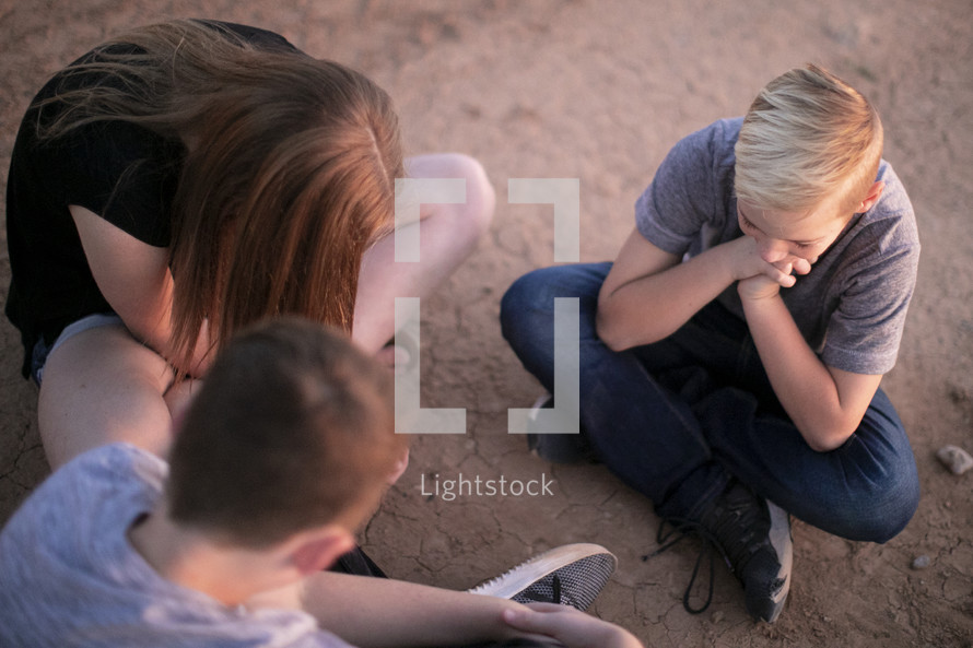 teens praying in a desert 