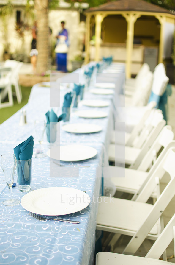 Outdoor wedding reception table and chairs.