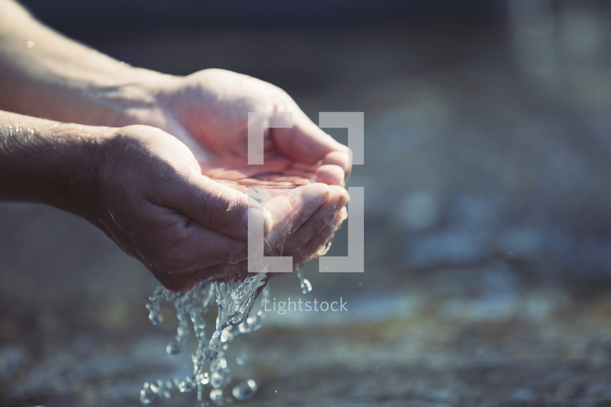 cupped hands holding clean water 