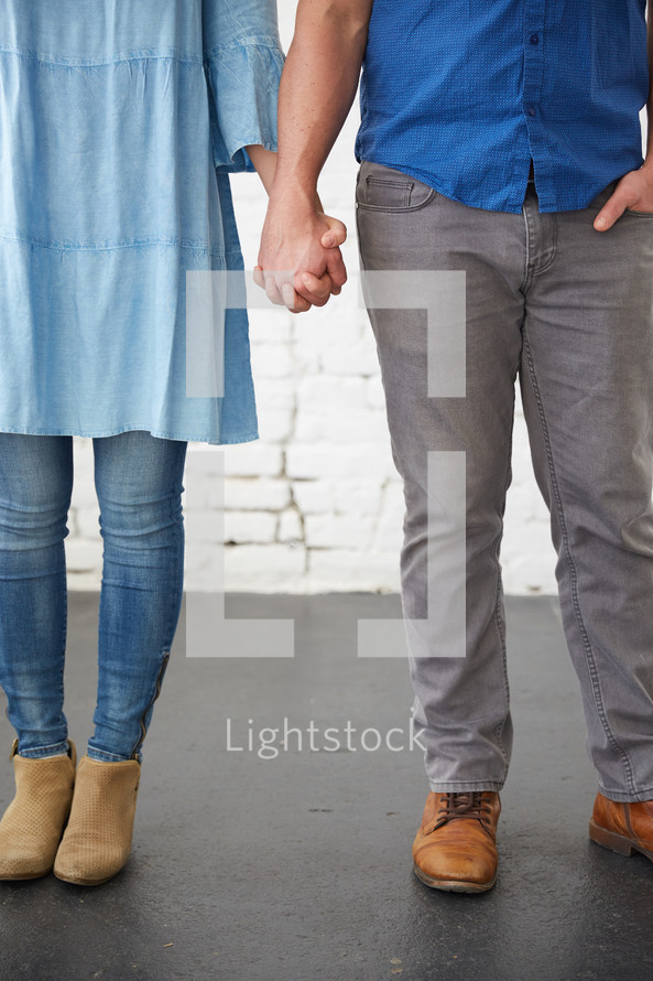 a couple holding hands 