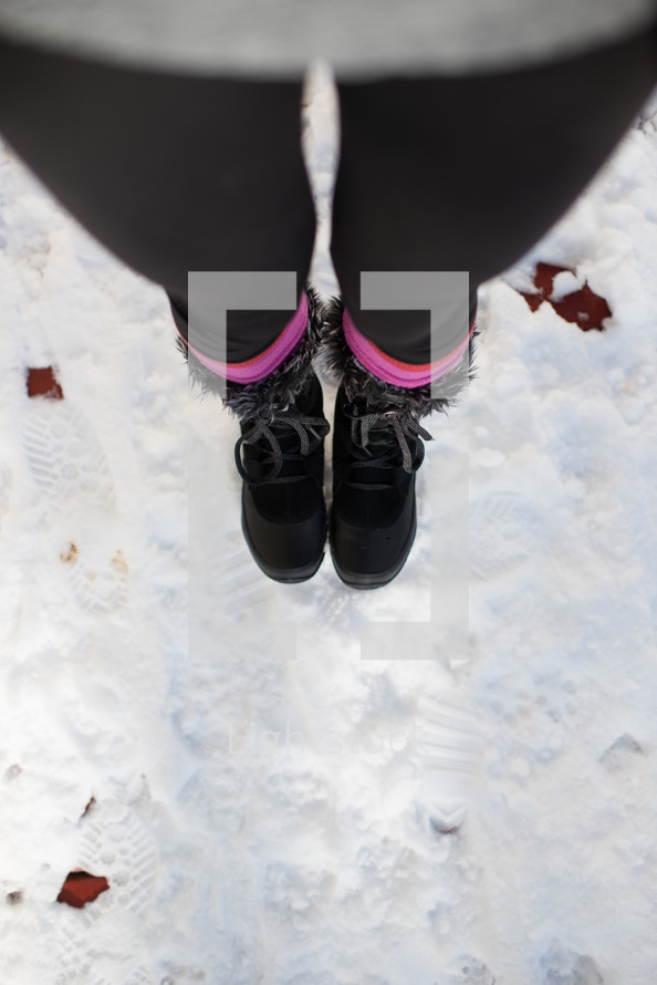 woman's snow boots in the snow 