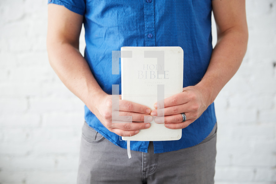 a man holding a Bible 