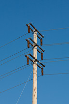 Wooden pole with power lines.
