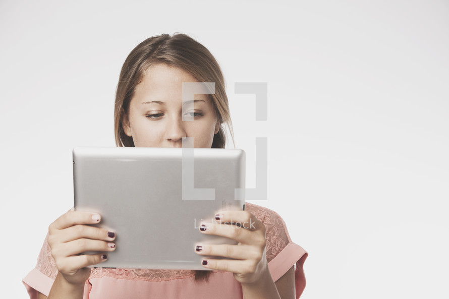 teen girl holding an iPad