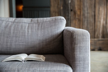 open Bible on a couch 