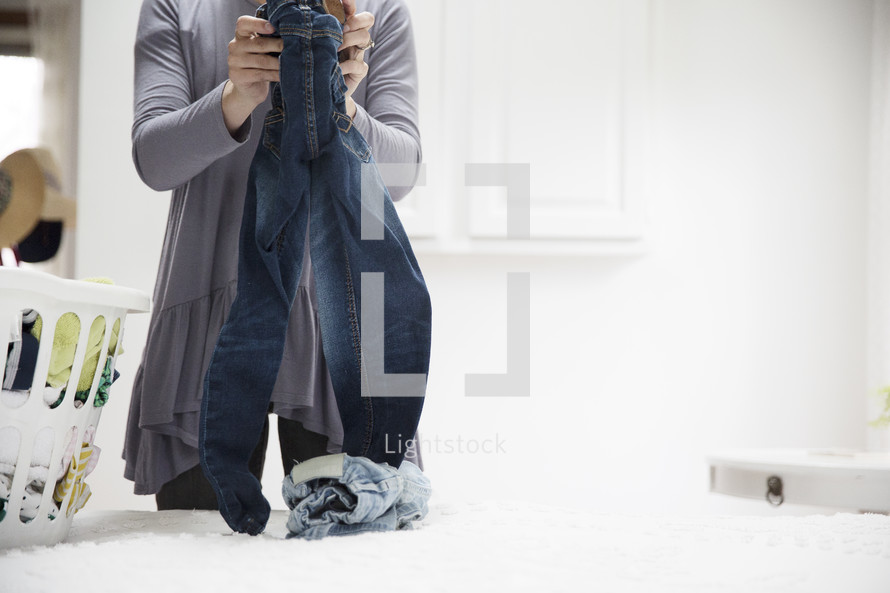 a woman folding clothes 