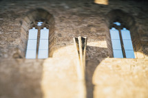 sunlight through a church window on a stone wall 