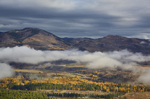 clouds hanging over a valley in fall 