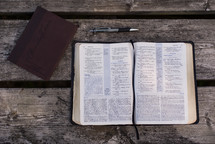 pen, journal, and open Bible 