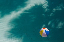 beach ball floating in a pool 