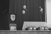 podium and balloons on stage for graduation 2017