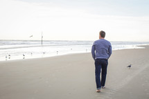a man walking on a beach 