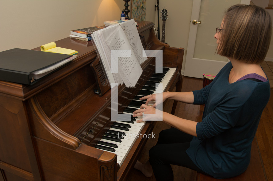 a woman playing and worshiping at a piano 