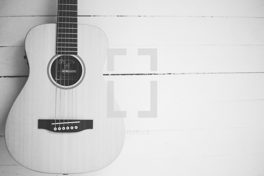 acoustic guitar on a wood floor 