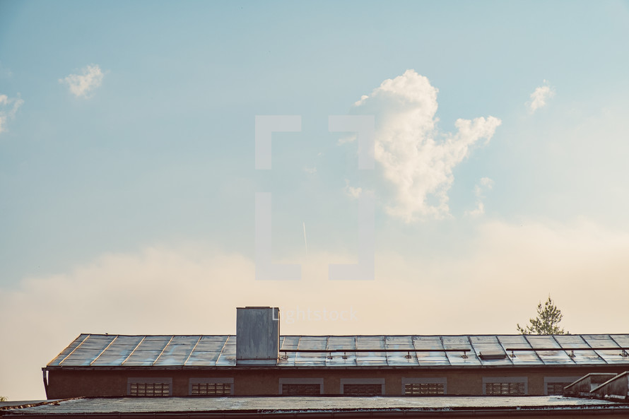 clouds over a factory rooftop 