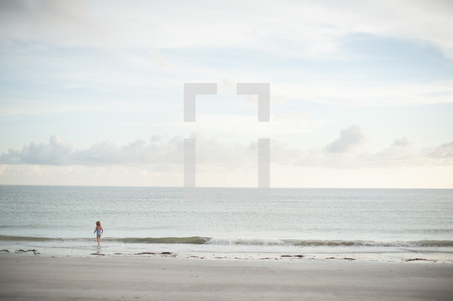 girl child walking on a beach