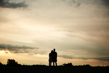 silhouette of a couple hugging 