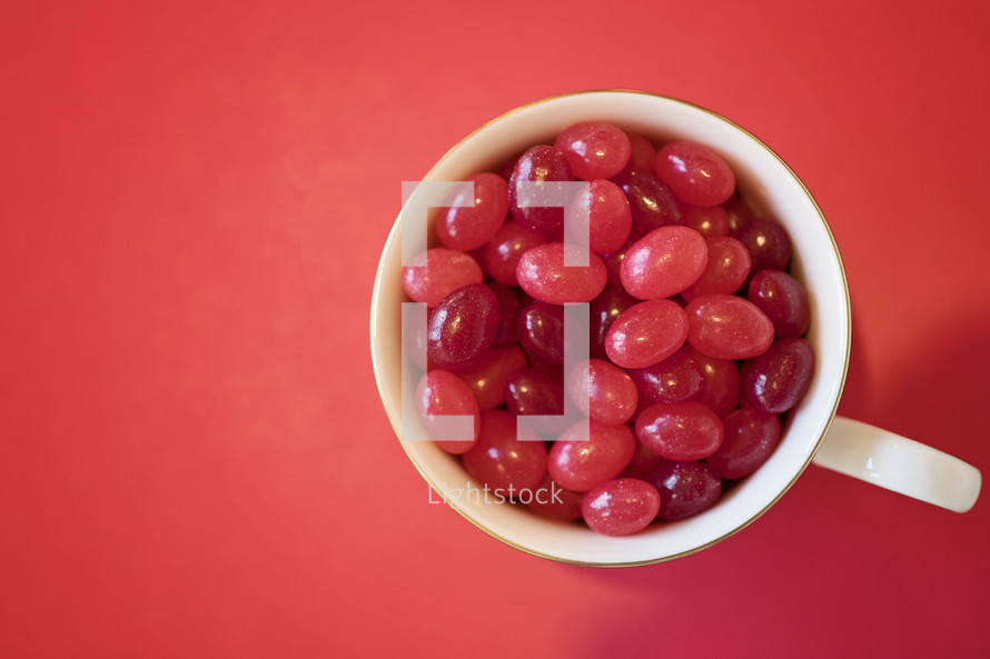 red jelly beans in a mug 