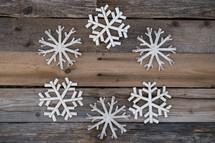 snowflake border on a wood background 