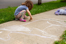 child drawing with chalk 