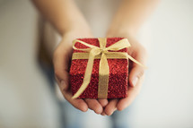 a woman holding a wrapped gift.