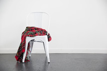 plaid blanket in a white chair 