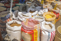 sacks of grains at an outdoor market 