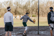 teen boys playing tetherball 