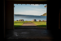 view of a lake through a shed opening 