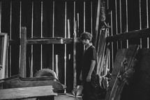 a teen boy in a barn 