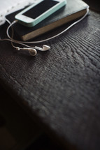podcast, iPod and earbuds on Bible 