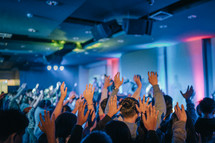 group worship - raised hands in an audience 