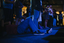 a man crying during a worship service 