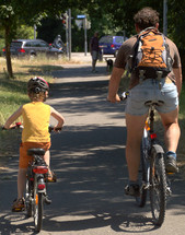 a father and his child biking